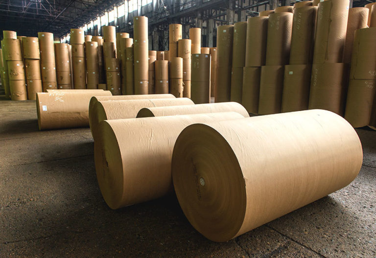 beige rolls of paper in warehouse floor stacked